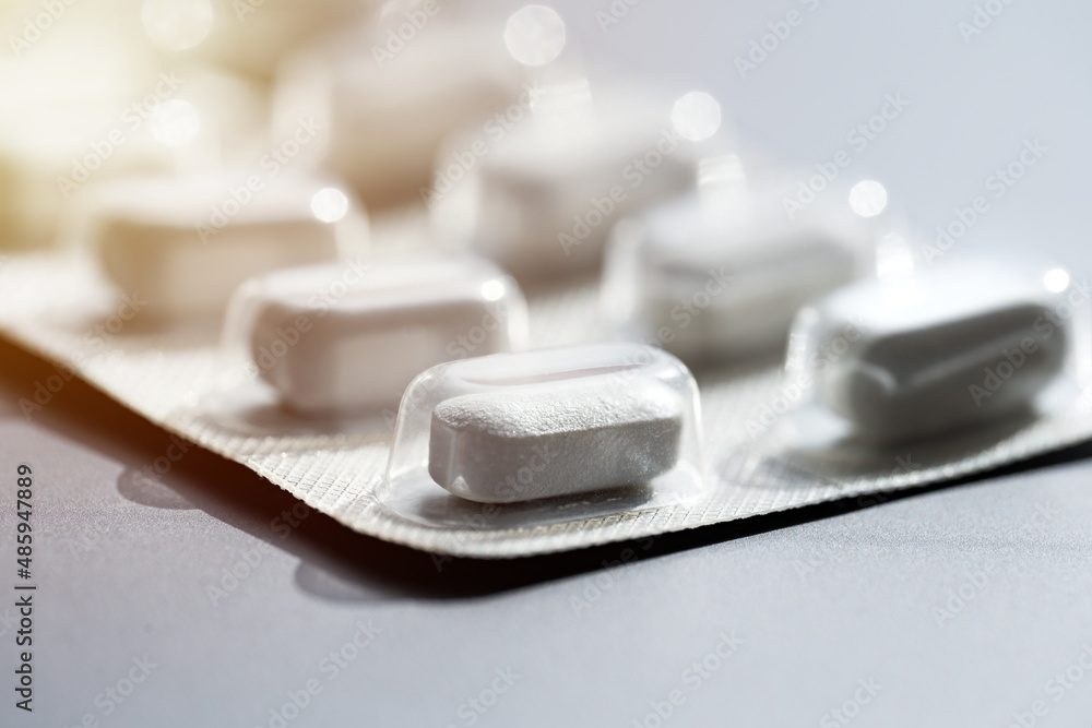 Closeup of pills in blister pack. Headache pills, painkillers, antibiotics or antidepressants tablets - obrazy, fototapety, plakaty 