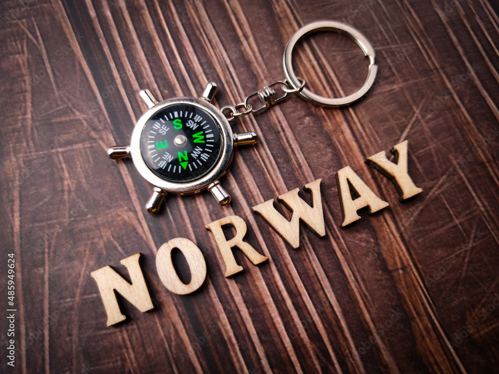 Top view compass and wooden word with text NORWAY on wooden background. Top view compass and wooden word with text NORWAY on wooden background.