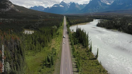 Aerial view of vehicles driving down the iconic Icefields Parkway route between Banff and Jasper National Parks in Alberta, Canada.