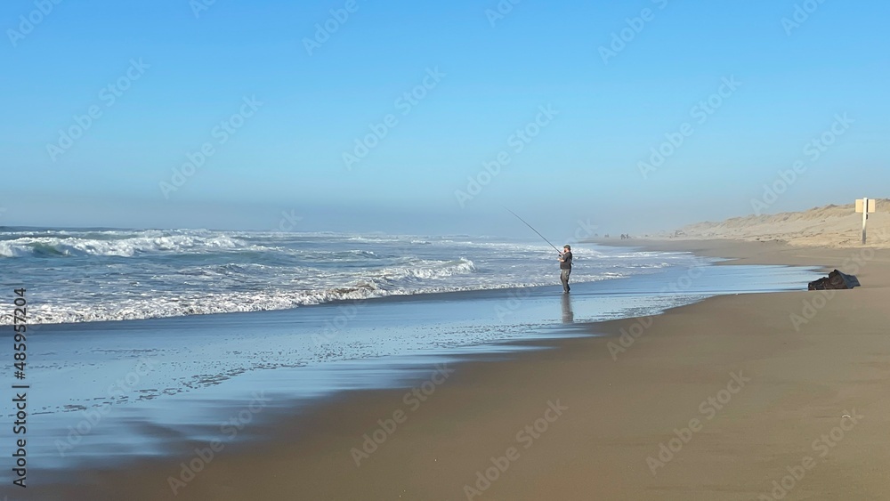 Man fishing on the beach on the Oregon Coast
