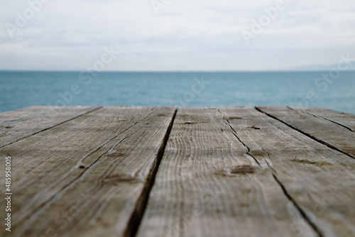 Blue beach and wooden table. abstract background
