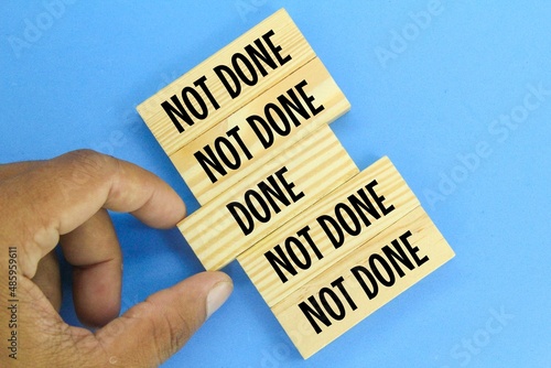 hands holding ready wood and left unprepared. concepts are done and not done