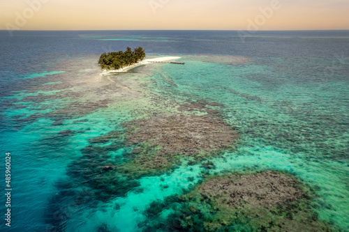 Remote Island surrounded by turquoise waters and beautiful underwater reef