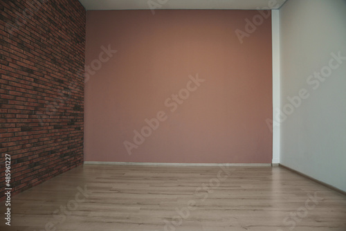 Empty room with different walls  white door and wooden floor