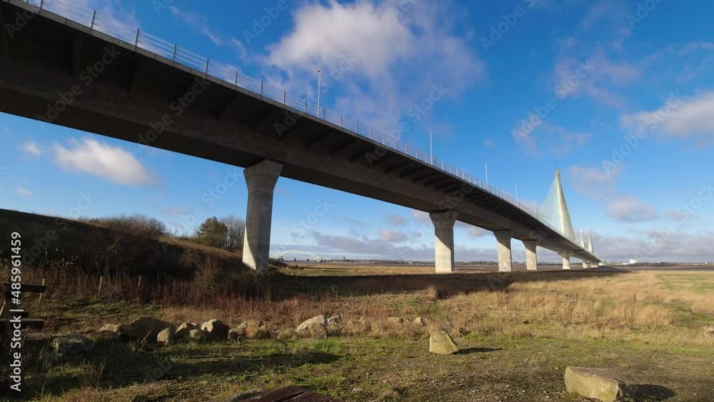 Fast moving clouds time lapse passing above Mersey Gateway cable bridge marshland under structure Fast moving clouds time lapse passing above Mersey Gateway cable bridge marshland under structure