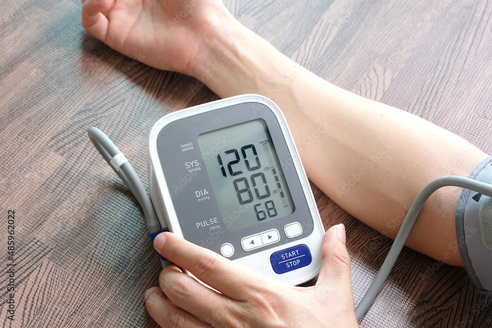 Man check blood pressure monitor and heart rate monitor with digital pressure gauge. Health care and Medical concept Man check blood pressure monitor and heart rate monitor with digital pressure gauge. Health care and Medical concept