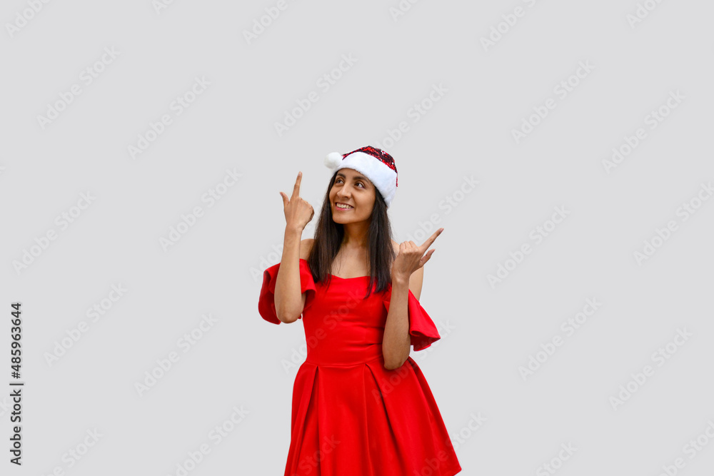 Beautiful woman with Santa Claus hat and red dress. Beautiful woman with Santa Claus hat and red dress.