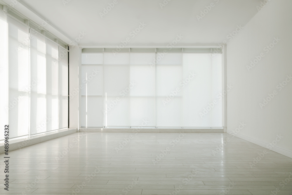 Empty room with panoramic windows and white wooden floor Empty room with panoramic windows and white wooden floor