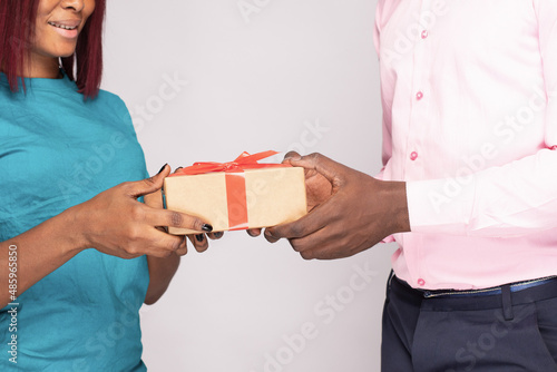 african lady receives a present from a man