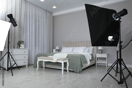 Professional photo studio equipment prepared for shooting bedroom interior