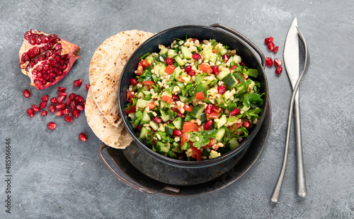 Fresh Tabbouleh salad on dark background. photo