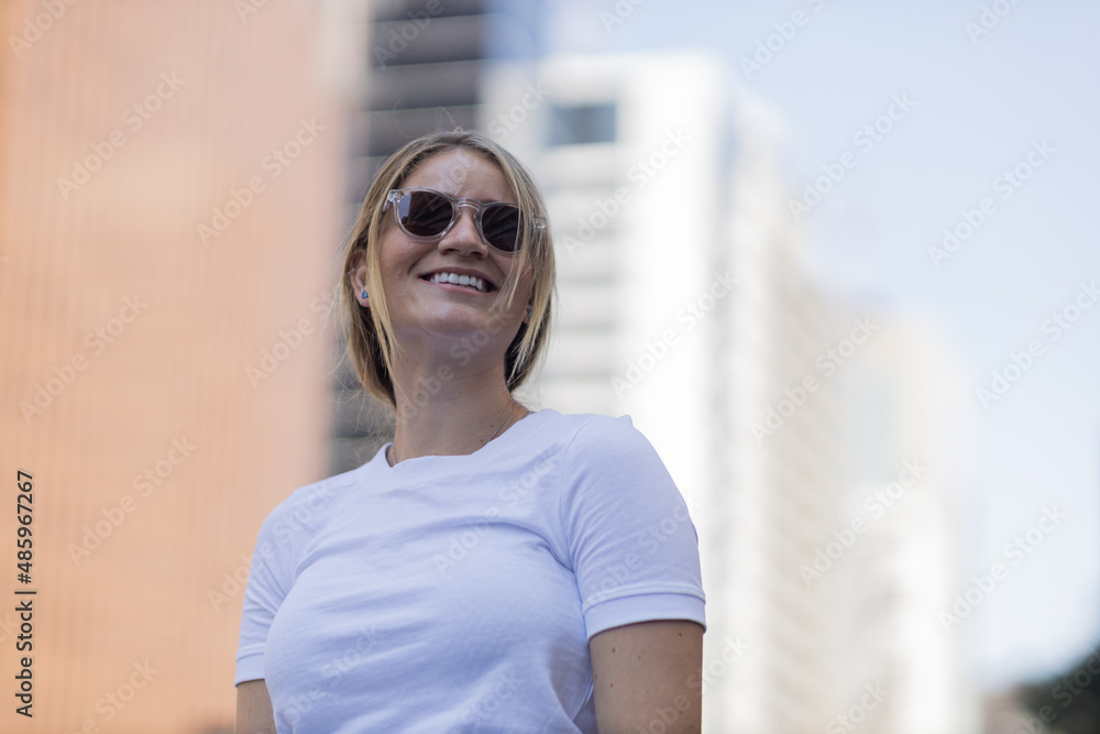 Portrait of a beautiful blonde woman on a big city street on an urban background. High quality photo Portrait of a beautiful blonde woman on a big city street on an urban background. High quality photo