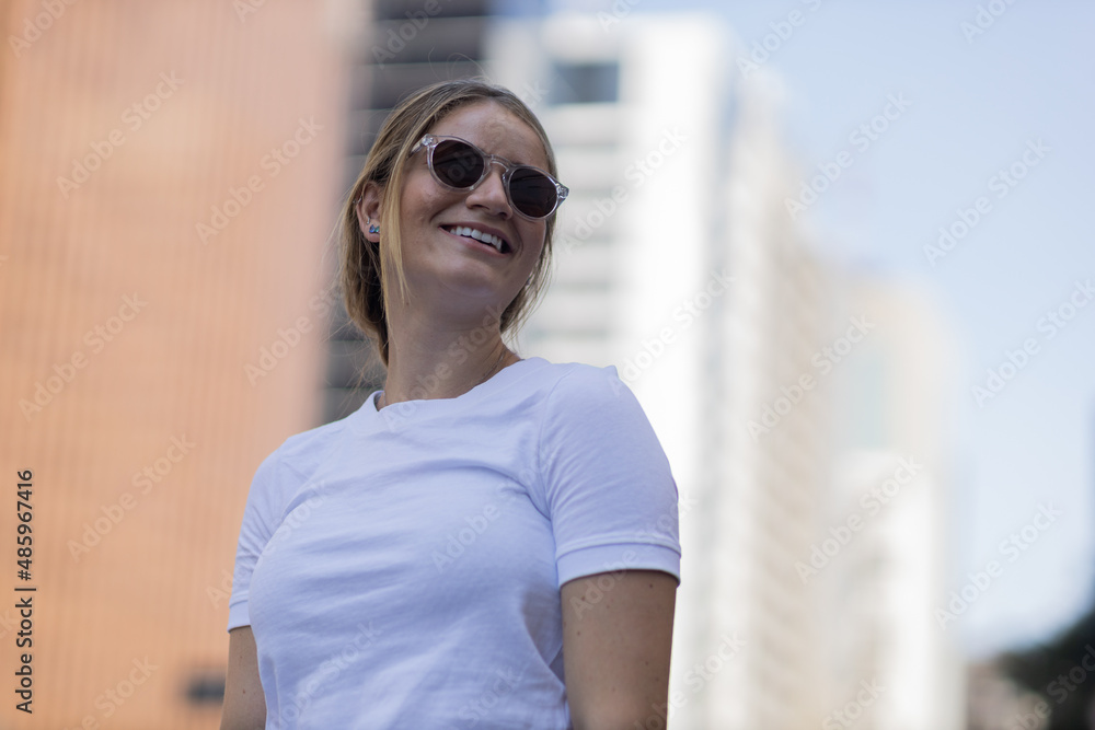 Portrait of a beautiful blonde woman on a big city street on an urban background. High quality photo Portrait of a beautiful blonde woman on a big city street on an urban background. High quality photo