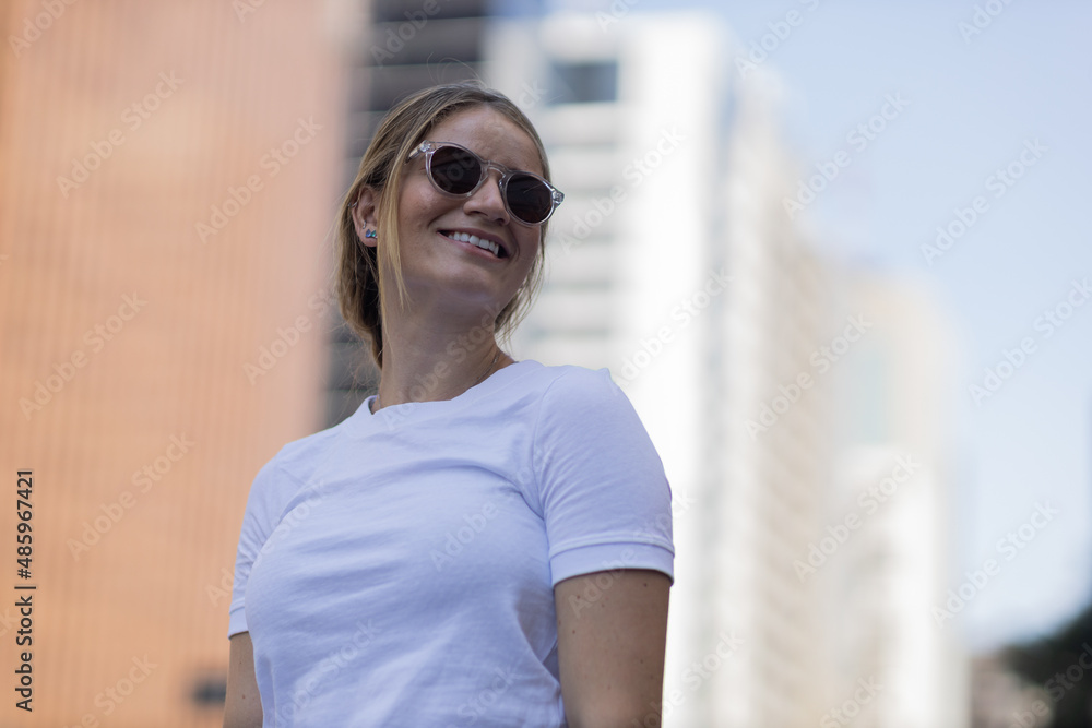 Portrait of a beautiful blonde woman  on a big city street on an urban background. High quality photo