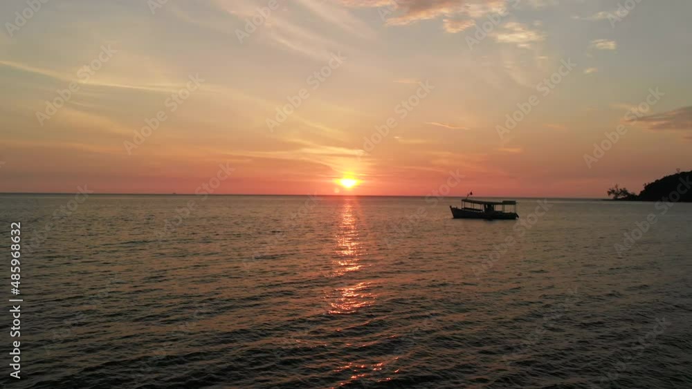 Romantic sunset with floating boat on sea in Cambodia, aerial drone view Romantic sunset with floating boat on sea in Cambodia, aerial drone view