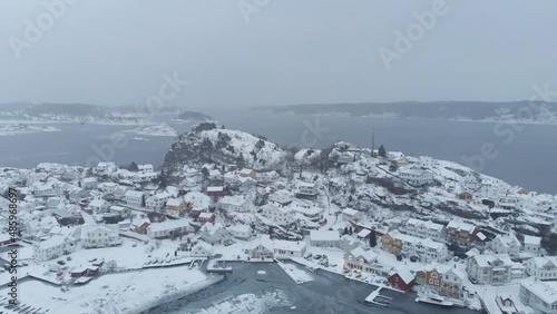 Wintertime View Of Viewpoint Veten - Oya Overlooking Kragerø Downtown And Foggy Archipelago In Norway. aerial pullback photo