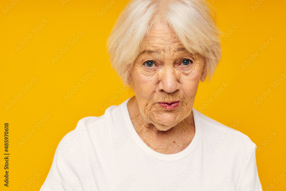 Photo of retired old lady posing face grimace joy yellow background Photo of retired old lady posing face grimace joy yellow background