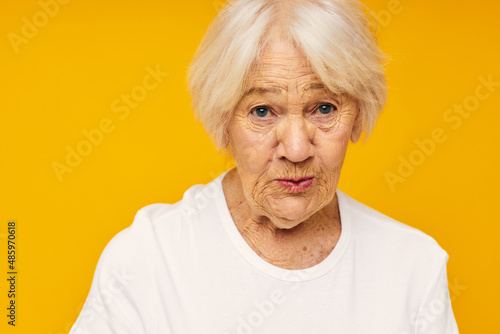 Photo of retired old lady posing face grimace joy yellow background