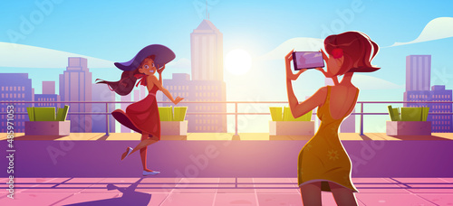 Woman posing on rooftop terrace for photo shoot. Girls in summer dresses stand on house roof photographing each other on mobile at cityscape background with skyscrapers, Cartoon vector illustration