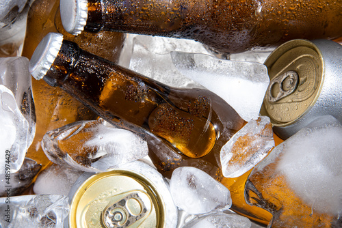 beer bottles with beer can chilled in ice