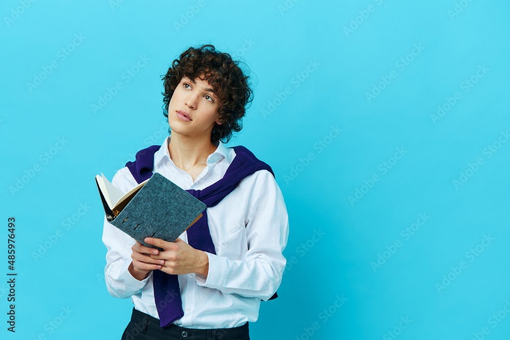 man with a notepad in a sweater shirt on the shoulders blue background man with a notepad in a sweater shirt on the shoulders blue background