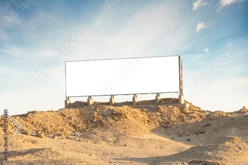 white colored blank billboard outdoors, outdoor advertising, public information board on land with blue sky photo