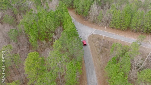Aerial shot following a Jeep Wrangler on a Rural Road photo