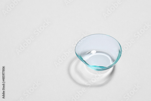 One contact lens on white background, space for text