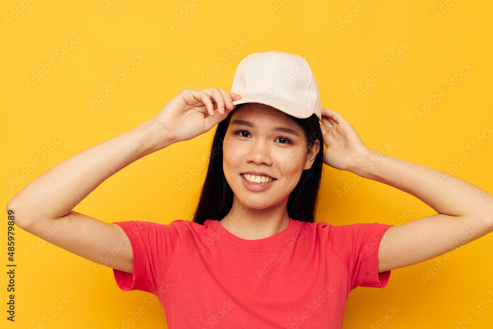 cheerful woman of asian appearance in a cap posing