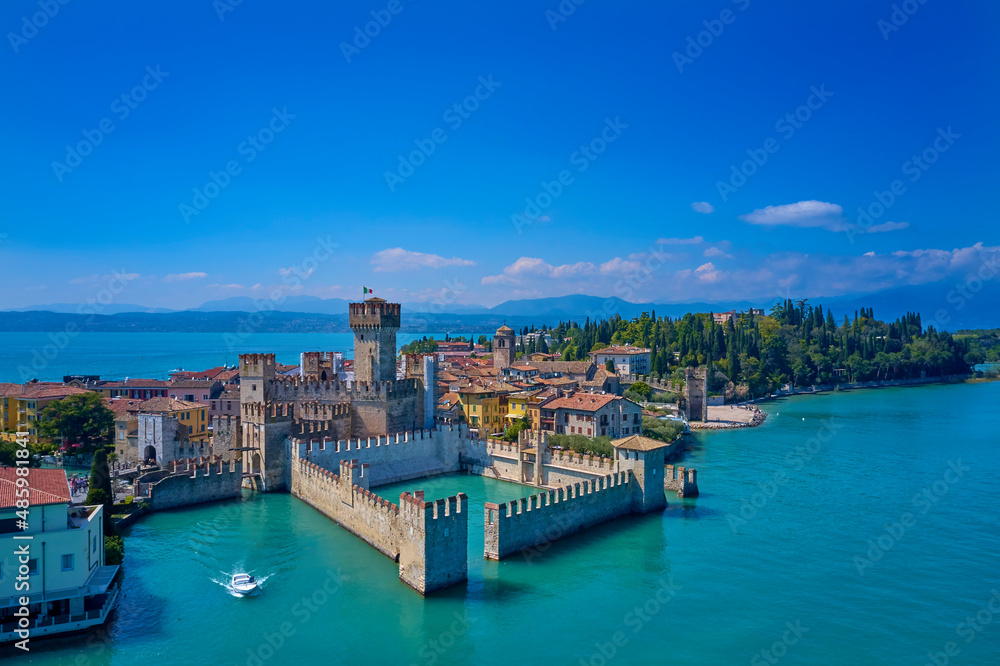 Aerial view of Sirmione. Sirmione Castle, Lake Garda, Italy. The flag of Italy on the main tower of the castle.