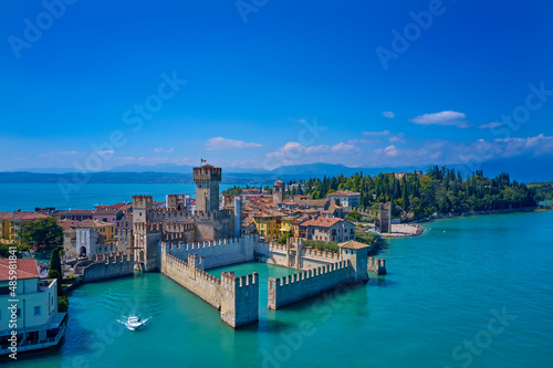 Aerial view of Sirmione. Sirmione Castle, Lake Garda, Italy. The flag of Italy on the main tower of the castle.