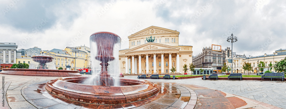 A wide panorama of the Bolshoi Theatre building and the fountain in front of it in Moscow, Russia