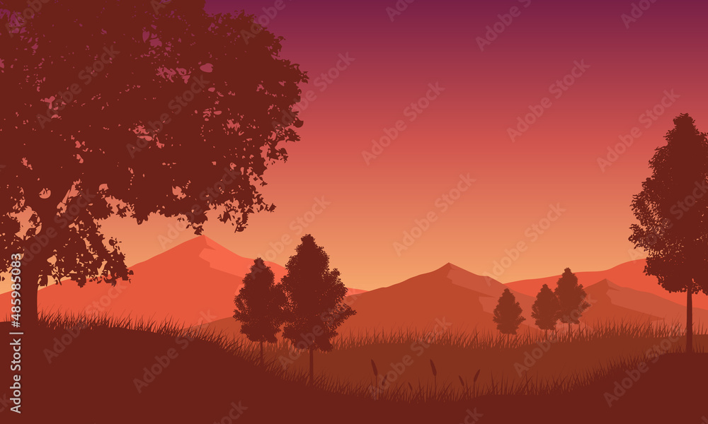 Beautiful mountain view at dusk with silhouettes of cypress trees and small grass around it