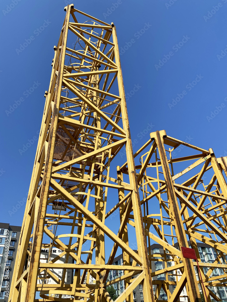 construction tower at a construction site on blue sky background. Industry new building business.