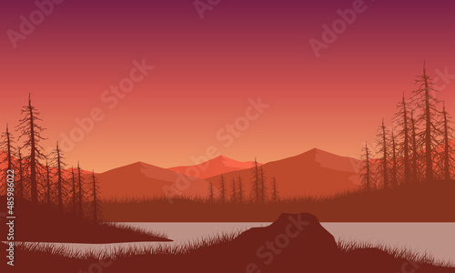 Realistic mountain view at dusk from lakeside with dry tree silhouettes around