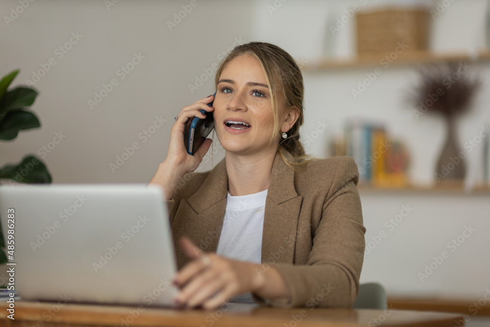 Young woman working at home with laptop and papers on desk. Home office concept. Young woman working at home with laptop and papers on desk. Home office concept.