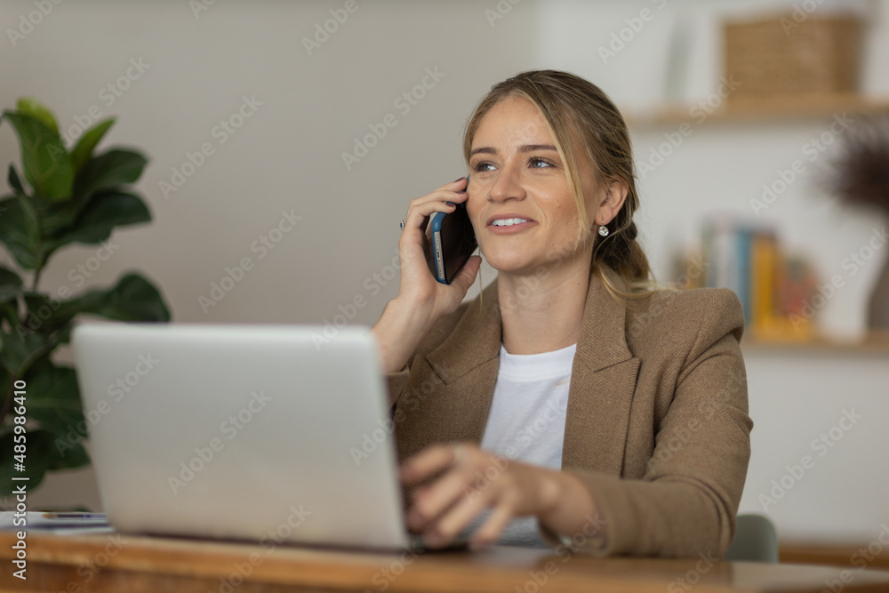 Young woman working at home with laptop and papers on desk. Home office concept. Young woman working at home with laptop and papers on desk. Home office concept.