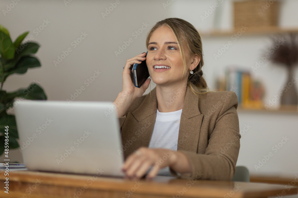 Young woman working at home with laptop and papers on desk. Home office concept. Young woman working at home with laptop and papers on desk. Home office concept.