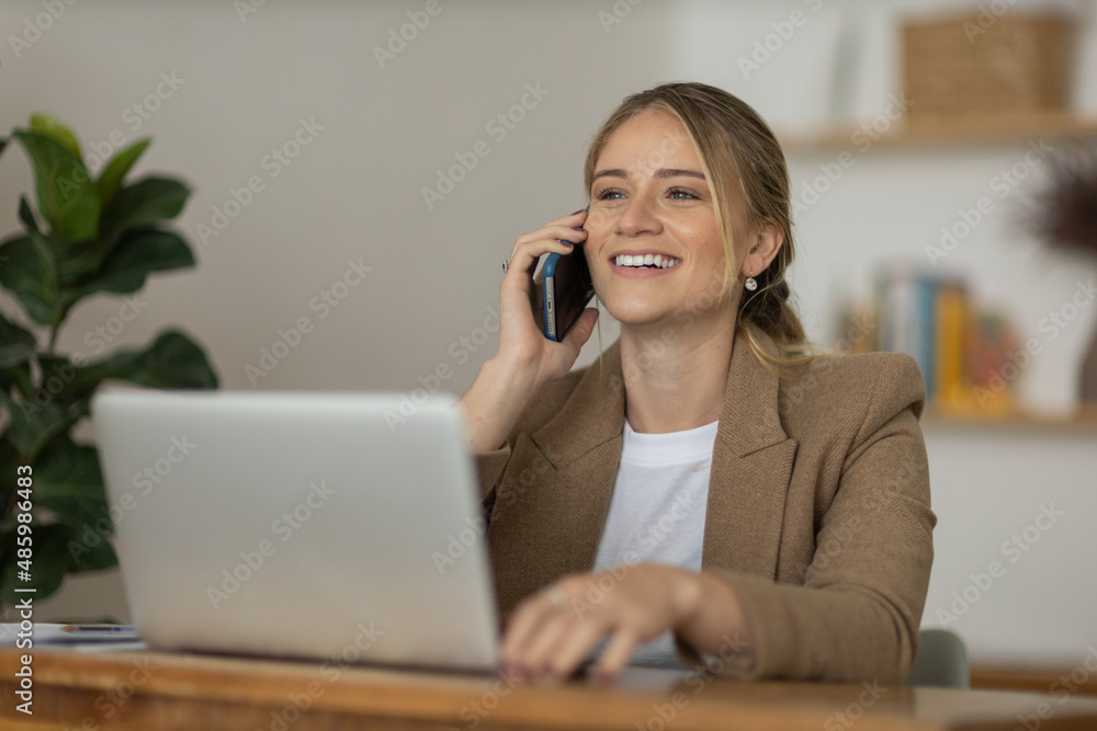 Young woman working at home with laptop and papers on desk. Home office concept. Young woman working at home with laptop and papers on desk. Home office concept.