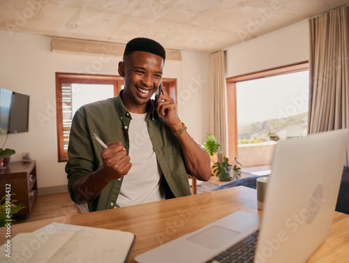 Canvas Print Young adult black male celebrating after receiving good news from work on a phone call