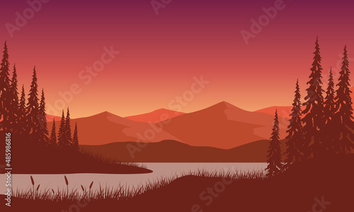 Stunning mountain view with dry tree silhouette and river from the outside city at sunset