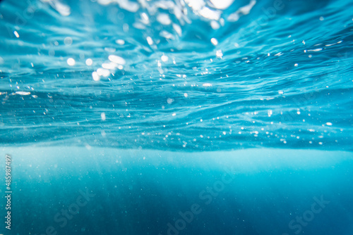 Clear blue water in ocean with sunlight