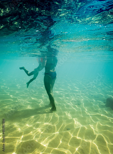 Mother teaching her son to swim in sea