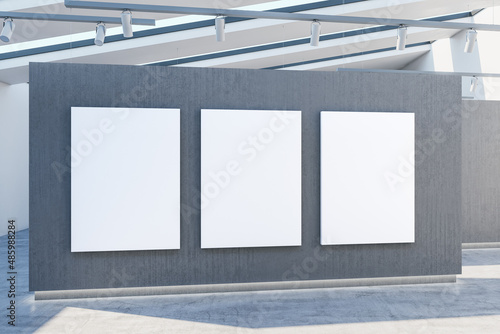 Modern concrete exhibition hall interior with empty mock up posters on wall and sunlight. 3D Rendering.