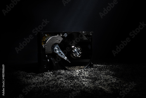Fotografie Information decay, hard disk under a layer of black powder