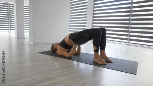 Young woman practicing hatha yoga at studio