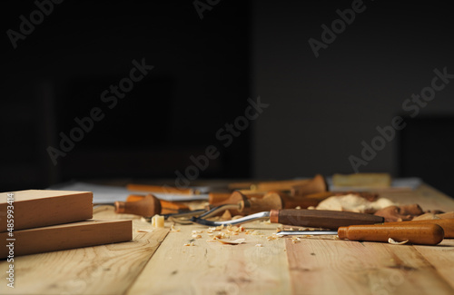 Woodworker's desk. Woodworking tools and shavings on a wooden table. Wood carving process concept with free space on top photo
