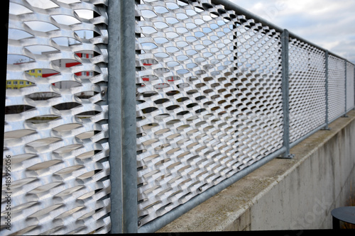 perforated expanded metal sheet metal fencing. Very durable railing made of galvanized railing frame. The strip of ornamental grasses gives the space an infustrial look. semi-transparent as a grater