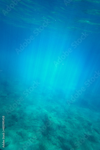 View of underwater sea with sunlight shining through surface © bruno135_406