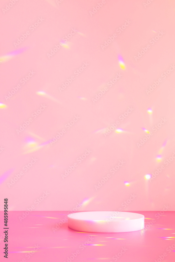 Abstract minimal scene - empty stage, cylinder podium on soft pink background with rainbow crystal light refraction sparkles. Pedestal for cosmetic product and packaging mockups display presentation